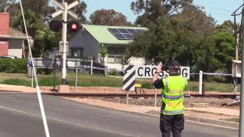 A teenage boy is fighting for life after a car he was travelling in collided with a train at a level crossing in Victoria's east.