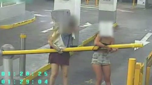 Two girls caught on CCTV attempting to lift a boom gate. (A Current Affair)