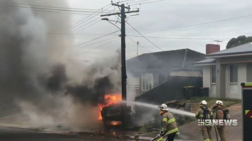 The burning car hit a power pole which had sparks flying from it as power was cut to hundreds of homes.