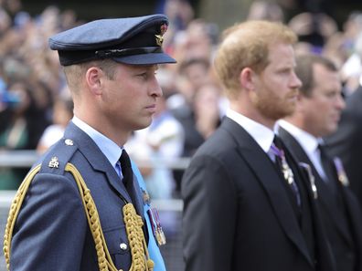 Prince William, Prince of Wales and Prince Harry, Duke of Sussex walk behind the coffin during the procession for the Lying-in State of Queen Elizabeth II on September 14, 2022 in London, England. Queen Elizabeth II's coffin is taken in procession on a Gun Carriage of The King's Troop Royal Horse Artillery from Buckingham Palace to Westminster Hall where she will lay in state until the early morning of her funeral. Queen Elizabeth II died at Balmoral Castle in Sco