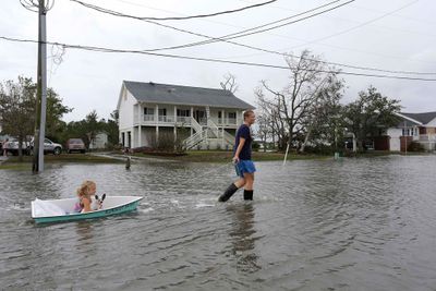A woman pulls her daughter along in a boat in Davis, North Carolina.