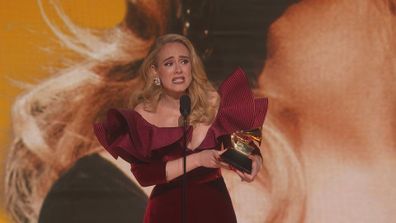 Adele accepts award at 2023 Grammys.