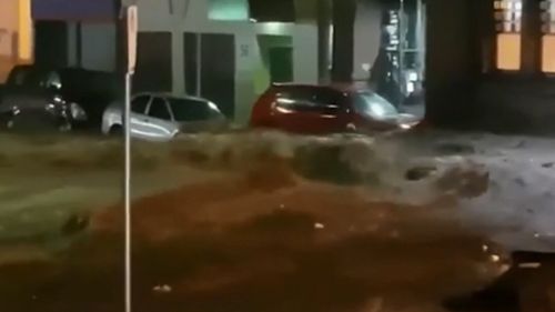 Footage captured cars beings swept away in the floodwaters. (9NEWS)