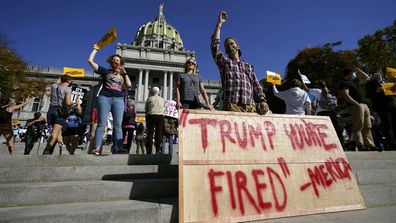 People celebrate outside the Pennsylvania State Capitol, Saturday, Nov. 7, 2020, in Harrisburg, Pa., after Democrat Joe Biden defeated President Donald Trump to become 46th president of the United States.