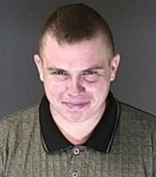 Richard Holzer smirked in a mugshot after his arrest.