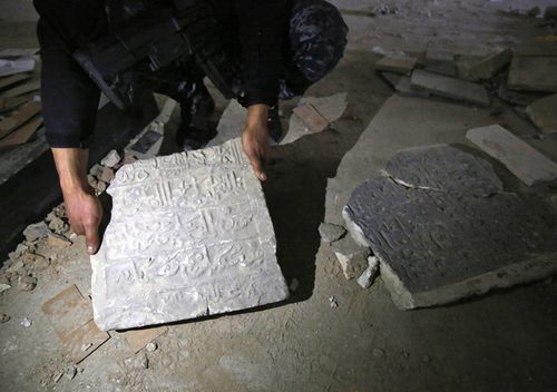 A member of the Iraqi forces holds damaged artefacts inside the destroyed museum of Mosul on March 13, 2017 after they recaptured it from Islamic State (ISIL) group fighters the previous week. Iraqi forces seized the museum from IS on March 7 as they pushed into west Mosul as part of a vast offensive to oust the jihadists from the northern city.