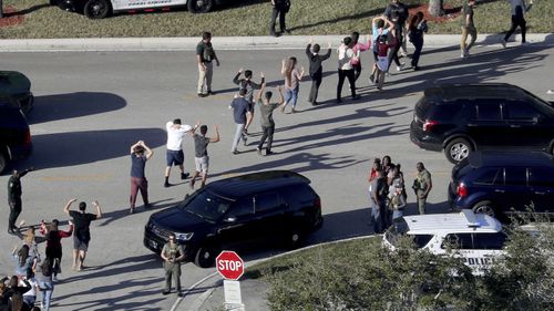 Students are led away from Marjory Stoneman Douglas High School in the aftermath of the shooting.