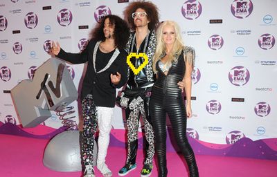 The afroed dance duo posed with 'Party Rock Anthem' pal Lauren Bennett on the red carpet...