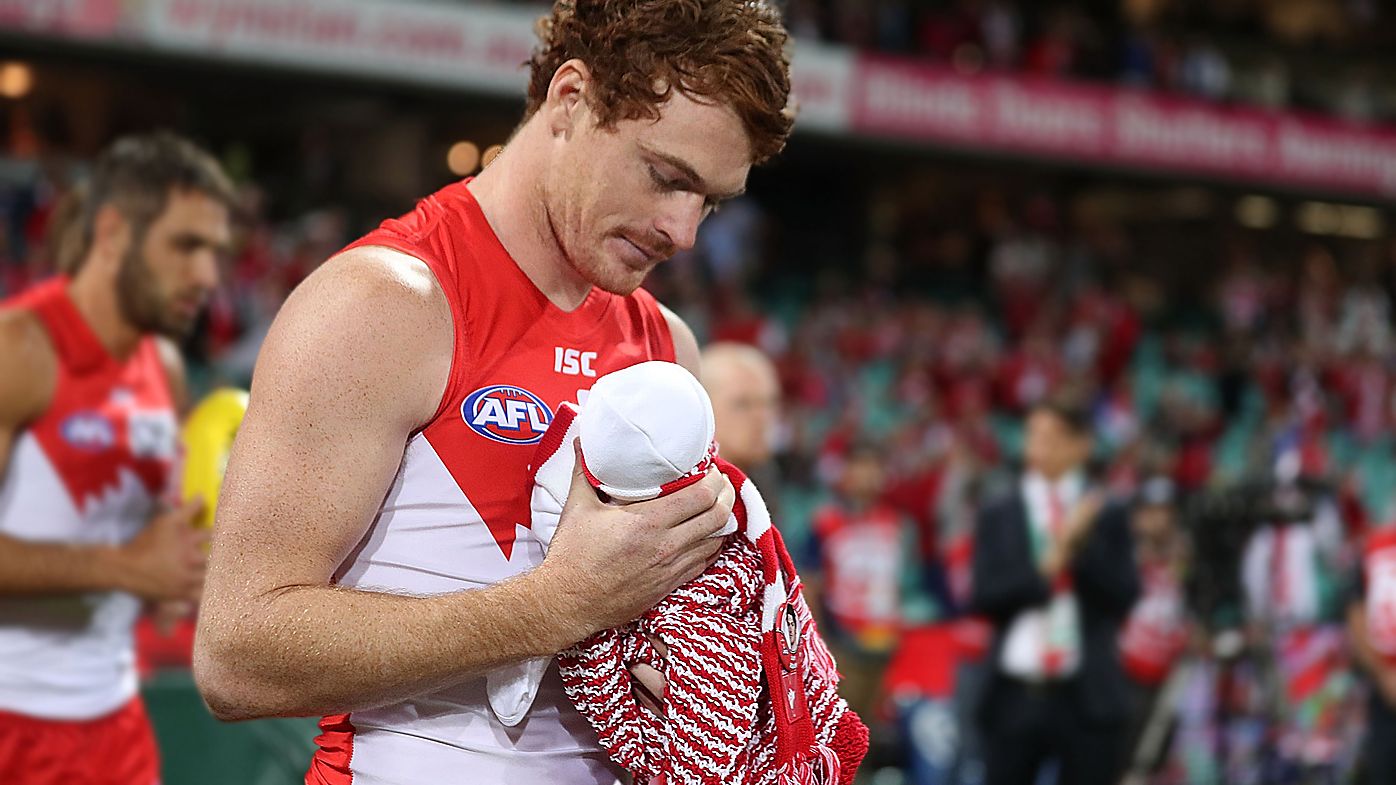 Sydney Swans star Gary Rohan walks out to game 100 with newborn baby Bella