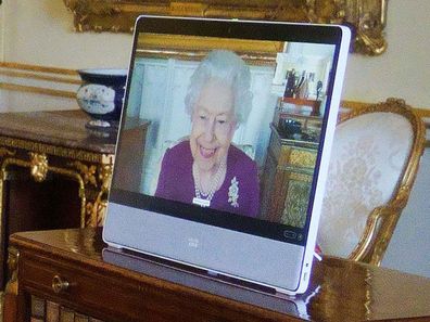 Queen Elizabeth II, in residence at Windsor Castle, appears on a screen via videolink, during a virtual audience to receive Fahad bin Mohammed Al-Attiyah, Ambassador of Qatar, and Sheikha Raya Khalifa Abdulla Khalifa Al Khalifa (L), at Buckingham Palace on March 22, 2022 in London, England