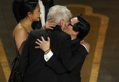 Harrison Ford, left, and Ke Huy Quan react onstage when "Everything Everywhere All at Once" wins the award for best picture at the Oscars on Sunday, March 12, 2023, at the Dolby Theatre in Los Angeles. (AP Photo/Chris Pizzello)