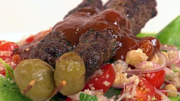 Lamb and olive skewers with tomato salad