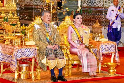 Thailand's King Maha Vajiralongkorn Bodindradebayavarangkun (Rama X), with Queen Suthida, sits under the Royal Nine-tiered Umbrella at Baisal Daksin Throne Hall in Bangkok.