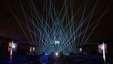 The Eiffel Tower is lit up with the Olympic Rings to close the opening ceremony.