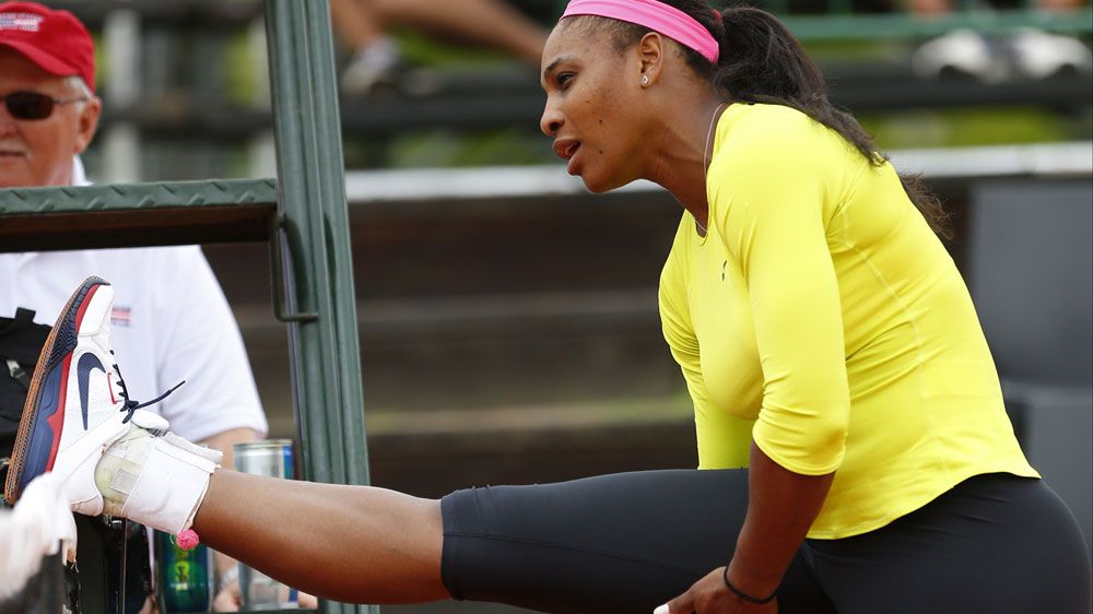 Serena Williams stretches during training. (Getty)