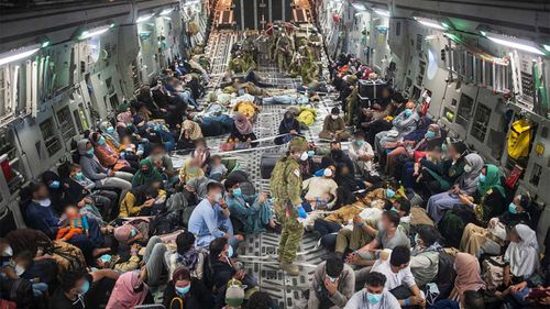 Australian citizens and Afghan visa holders aboard a C-17A Globemaster III leaving Kabul.