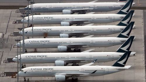 Cathay Pacific planes lay idle on the tarmac at Hong Kong Airport.