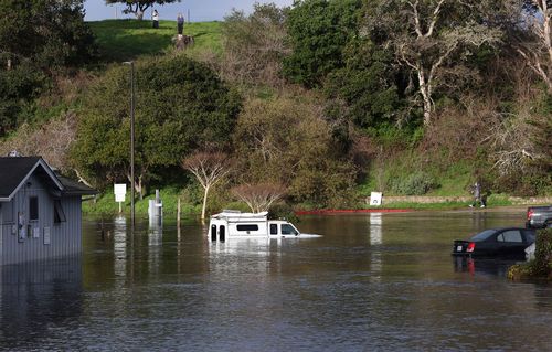 A tsunami surge inundates the parking lot at the top of the Upper Harbor in Santa Cruz, California.