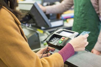 Woman paying for groceries.