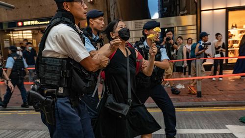Chan Po Ting, an activist and leader of League of Social Democrats, is detained by police officers at Causeway Bay near Victoria Park on June 04, 2023 in Hong Kong, China. 
