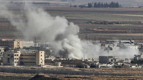 Smoke rises over the Syrian town of Ras al-Ain, as seen from the Turkish border on October 15, 2019 in Ceylanpinar, Turkey.