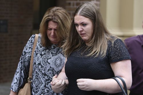 Cassie Dillon (right), the sister of Bradley Dillon, leaves the NSW Supreme Court today. (AAP)