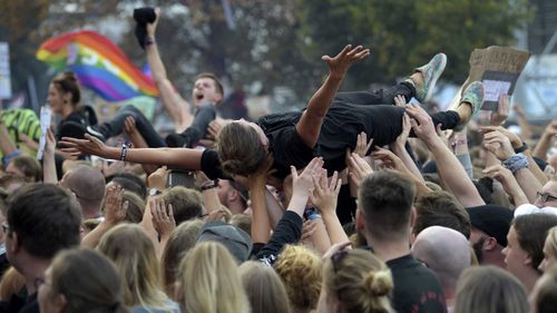 Crowdsurfers revel during an anti-racism concert in Chemnitz held on Monday.