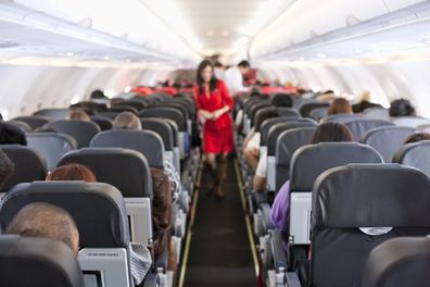 Passengers inside the cabin of a plane during a flight