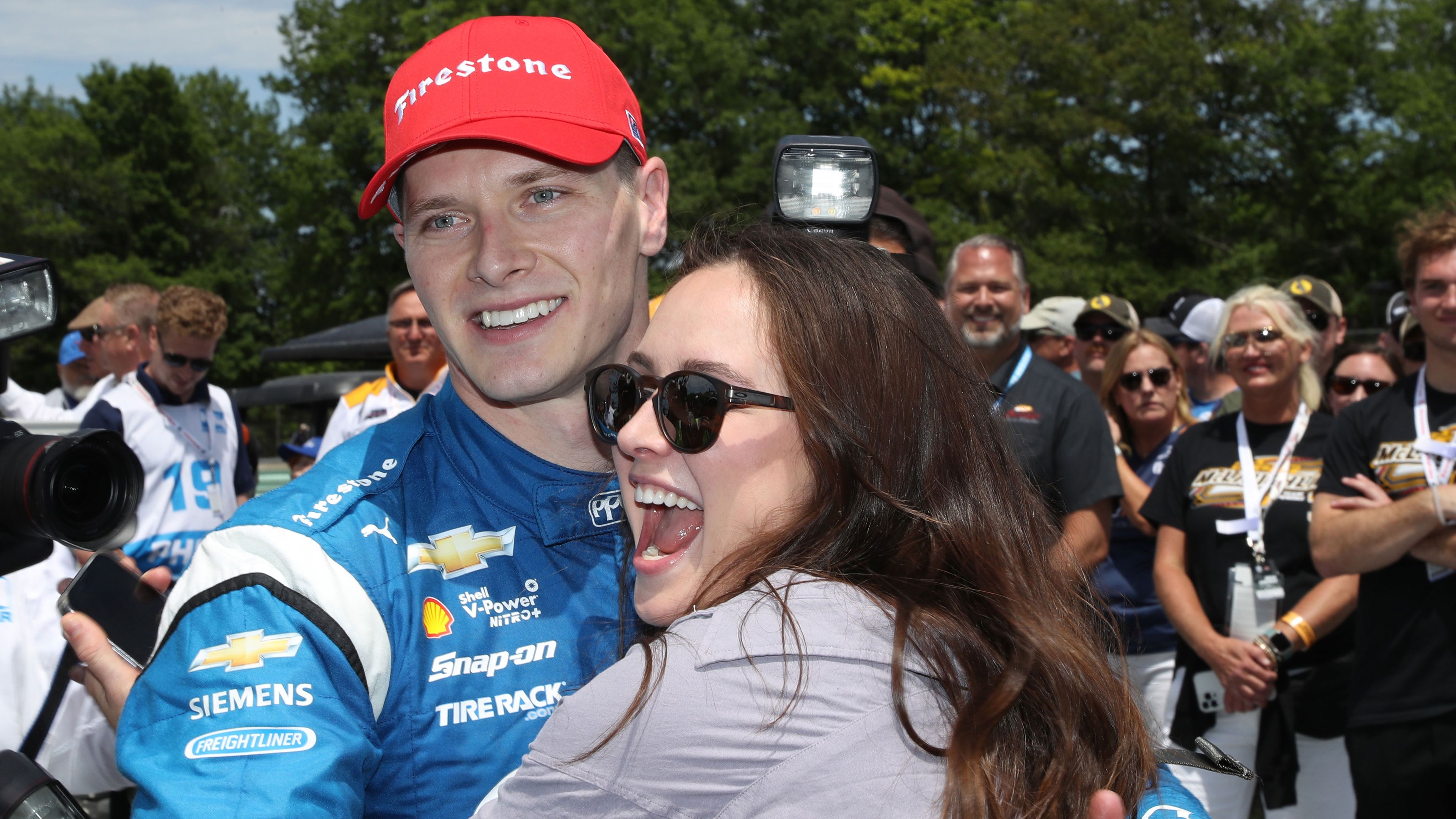 NTT IndyCar series driver Josef Newgarden gets a hug from his wife Ashley after winning the Sonsio Grand Prix at Road America.