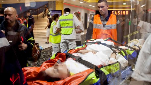 A victim is rushed to hospital after a gunman drove a truck into a crowd at Bastille Day celebrations in Nice. (Getty)