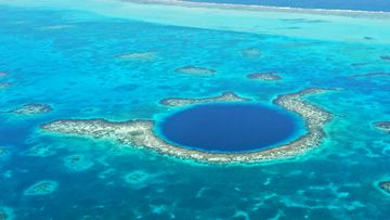 Situated in the centre of Lighthouse Reef off the coast of Belize, the Blue Hole is a giant marine sinkhole that is 318 m in diameter and 124m deep.