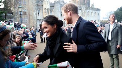 Prince Harry and Meghan Markle sign autographs and shake hands with children as they arrive to a walkabout at Cardiff Castle on January 18, 2018 in Cardiff, Wales.  (Photo by Chris Jackson/Chris Jackson/Getty Images)