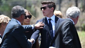 Sean Abbott is comforted as he arrives at the service. (Getty Images)
