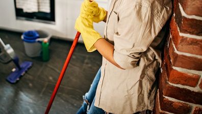 Couple cleaning kitchen.