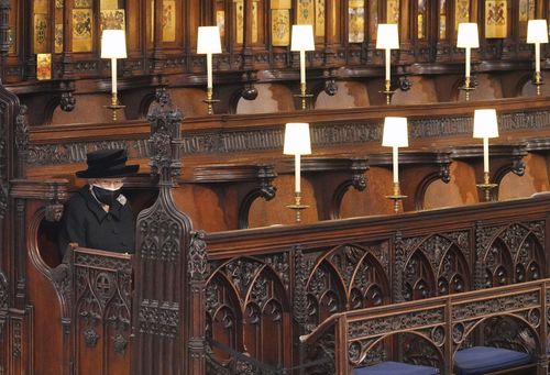 La reine britannique Elizabeth II la regarde assise seule dans la chapelle Saint-Georges lors des funérailles du prince Philip, l'homme qui était à ses côtés depuis 73 ans, au château de Windsor, à Windsor, en Angleterre, le samedi 17 avril 2021. Prince Philip est décédé le 9 avril à l'âge de 99 ans après 73 ans de mariage avec la reine britannique Elizabeth II.  (Jonathan Brady / Piscine via AP)