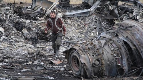 Search and rescue specialists inspect at the crash area of Malaysia Airlines Boeing 777, which was carrying 295 people and flying from Amsterdam to Kuala Lumpur. (All images Getty)