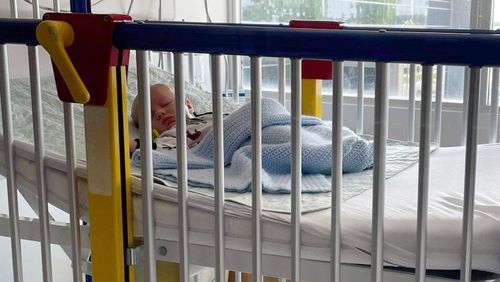 In this June 2021 photo, a six-week-old baby boy, Beau, lies in a hospital bed in Matoon, Illinois. Beau developed a bad cough after his dedication ceremony at church. His mother, who has a medical background, suspected respiratory syncytial virus when she opened his sleeper and saw his chest heaving with laboured breathing. (LaRanda St. John via AP)