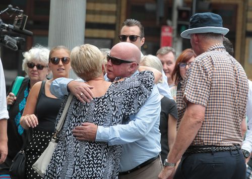 The family of Ms McGrath embrace outside Downing Centre Local Court before Grice's sentencing this afternoon. (AAP)