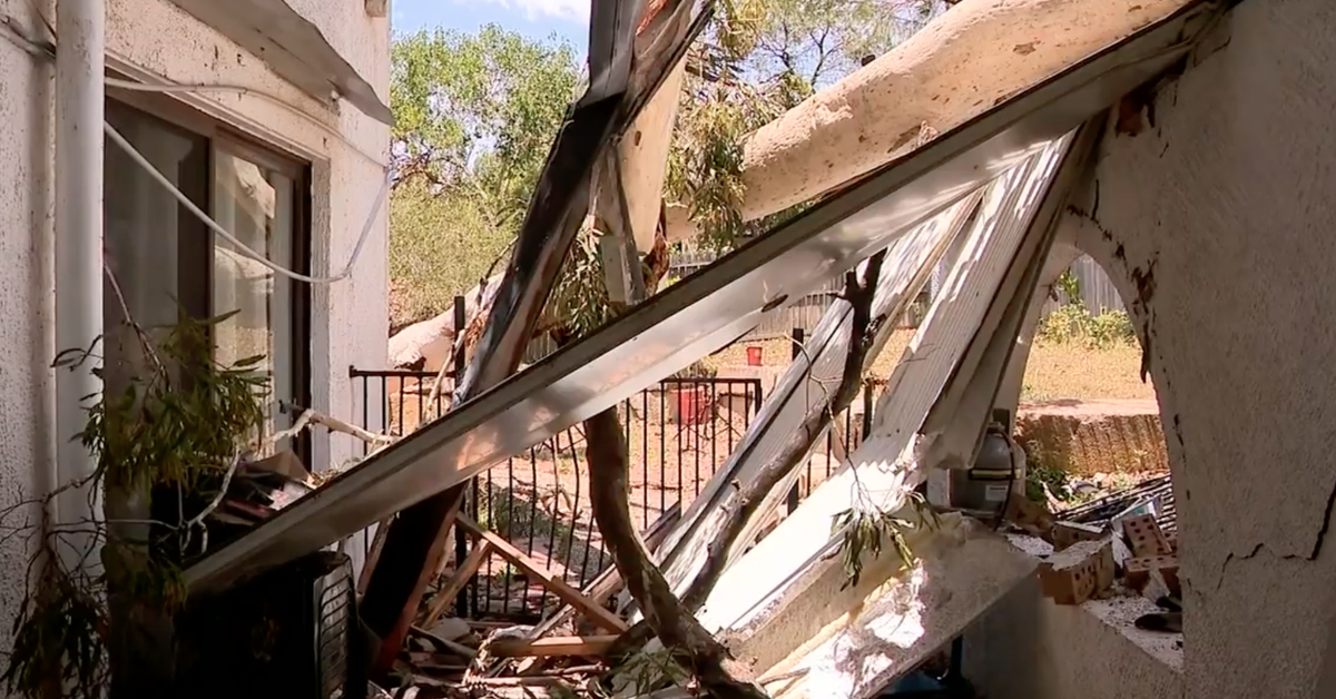 Trees crash through roofs, wild storm leaves tens of thousands without power on sweltering day