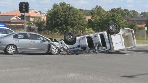 A police paddy wagon has rolled into its roof after colliding with a Honda Accord in Sydney's south west.