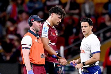 Jordan Petaia of the Reds is taken from the field injured during the round nine Super Rugby Pacific match against the Highlanders.