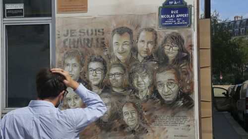 French street artist Christian Guemy, aka 'C215' in Paris pays tribute to the members of the satirical newspaper Charlie Hebdo attack by jihadist gunmen in January 2015. 