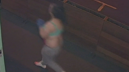 CCTV footage captures the 44-year-old woman minutes before she was arrested storming through a street in Melbourne with a top wrapped around her hand and blood dripping from her. 