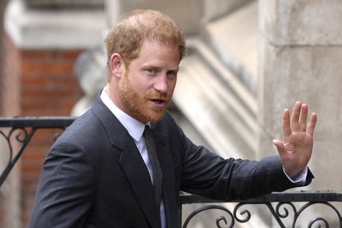 Prince Harry salutes media as he arrives at the Royal Courts Of Justice in London, Thursday, March 30, 2023.