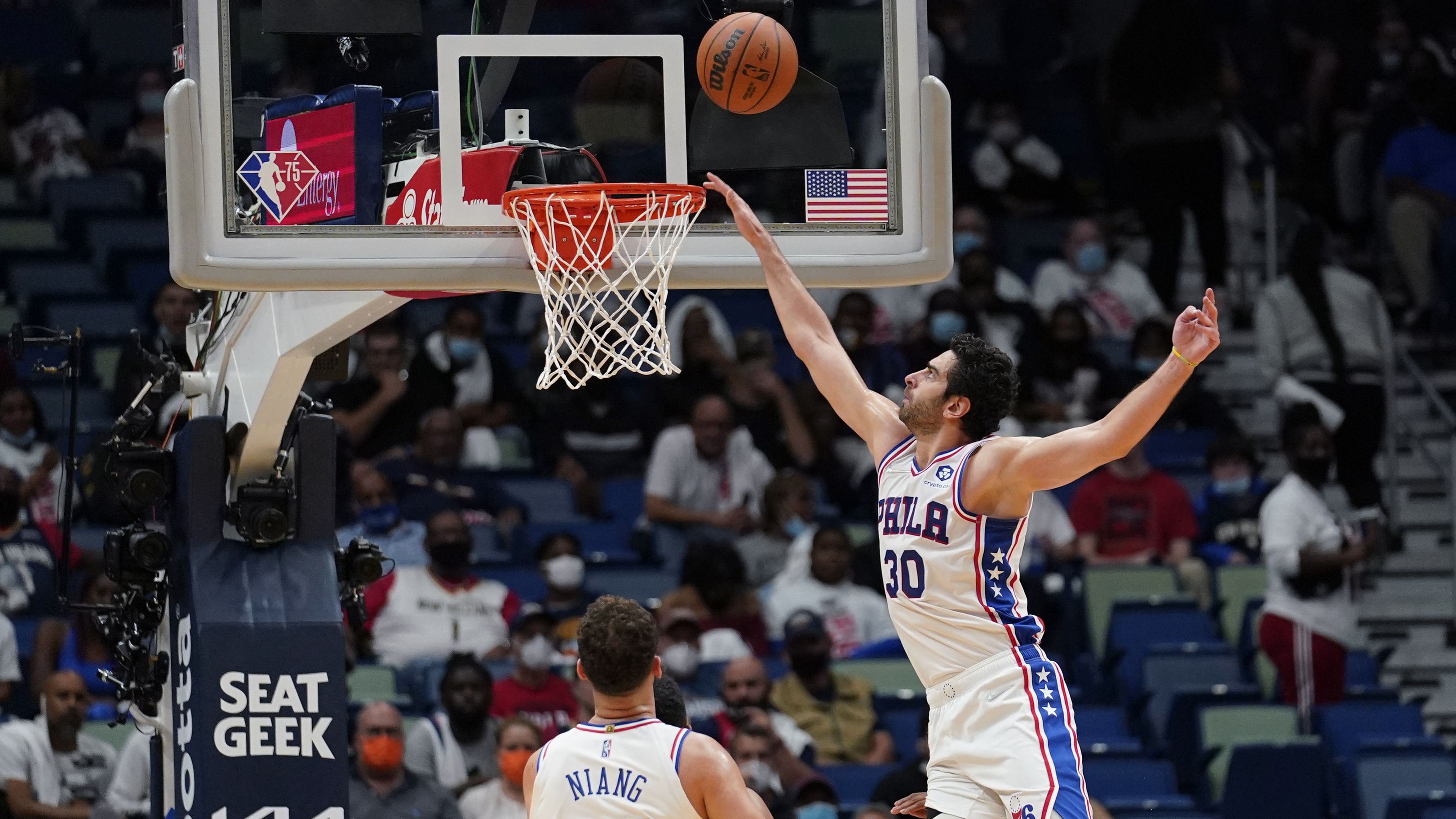 Philadelphia 76ers guard Furkan Korkmaz goes to the basket over forward Georges Niang in the second half of an NBA game against the New Orleans Pelicans.
