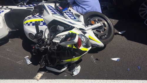 The officer was at his motorcycle when a passing Mazda rammed into him and also hit the Subaru he had pulled over.