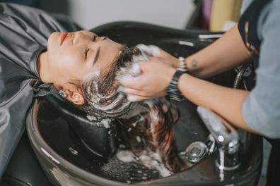 Woman in hairdresser haircut stock image