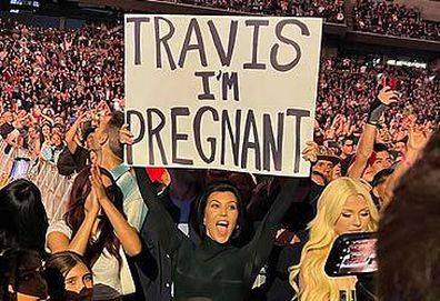 Kourtney Kardashian with 'Travis I'm Pregnant' poster (Instagram)