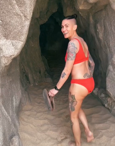 Woman looking in cave in Mexico