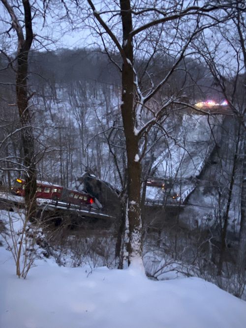 A commuter bus sits upright on a section of a collapsed bridge in Pittsburgh, on Friday, Jan. 28, 2022.
